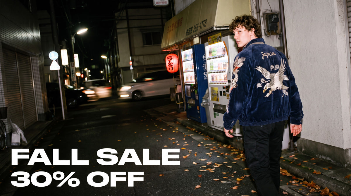 Hokuro Fall Sale 30% off - model wearing the Eastern Dragon embroidered souvenir jacket in a Tokyo street at night