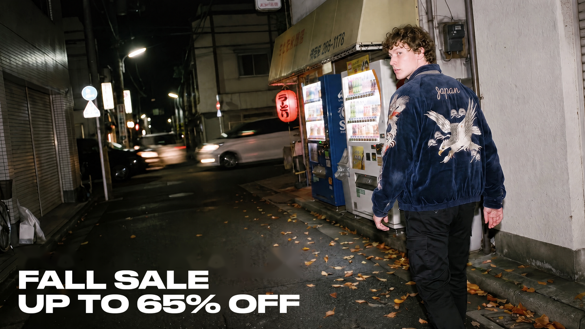 Hokuro Fall Sale up to 65% off - model wearing an embroidered souvenir jacket in a Tokyo street at night